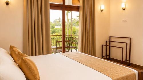 a bedroom with a bed and a large window at The Oak Residence in Ragama