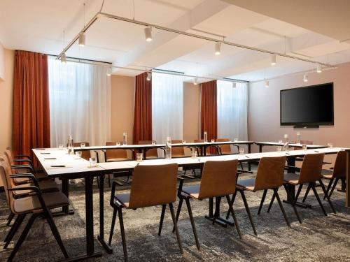 a large conference room with a large table and chairs at Hotel Les Capitouls Toulouse Centre - Handwritten Collection in Toulouse