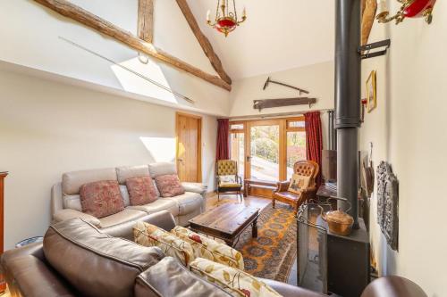 a living room with a couch and a fireplace at 4 Bed in Hawkshead oc-lr116 in Hawkshead