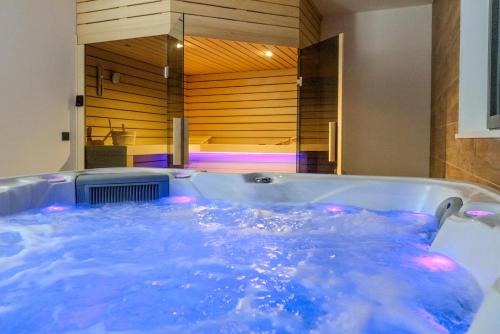 a bath tub filled with blue water in a bathroom at Villa Josip in Sukošan