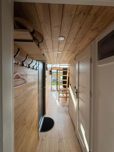 a hallway of a house with a wooden ceiling at Domek nad plażą in Chańcza