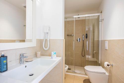 a bathroom with a sink and a toilet and a shower at TH Ostuni - Ostuni Village in Ostuni