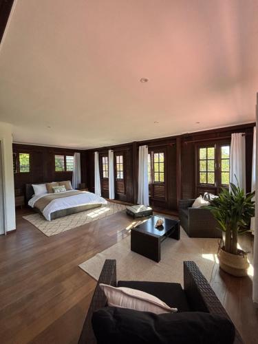 a large bedroom with a bed and a couch at KAZ DIBWA Beach House in Glacis