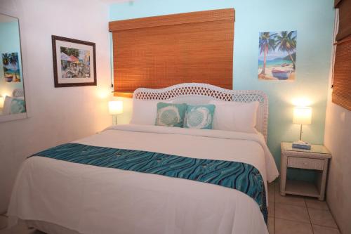 a bedroom with a large white bed with two lamps at Point Pleasant Resort® 1BR Suite with Ocean Views in Nazareth