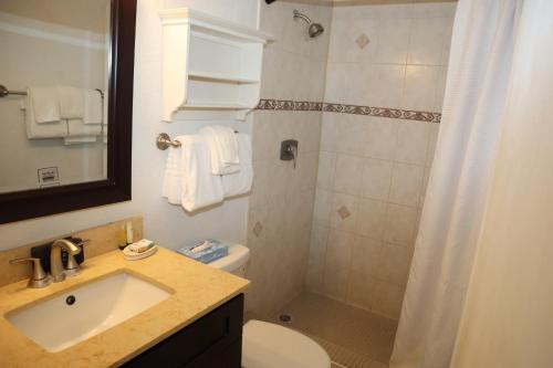 a bathroom with a sink and a toilet and a shower at Point Pleasant Resort® 1BR Suite with Ocean Views in Nazareth