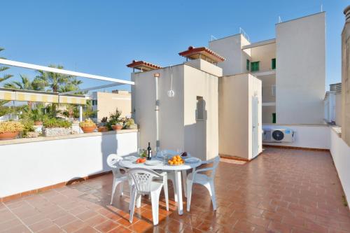 a patio with a table and chairs on a balcony at 28 Townhouse 200mts from sea/beach in Palma de Mallorca