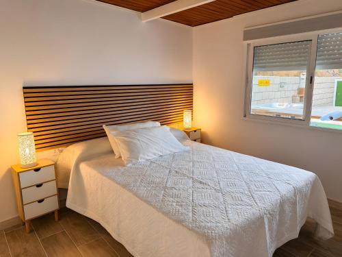 a bedroom with a white bed and a window at Finca Domingo in Fasnia
