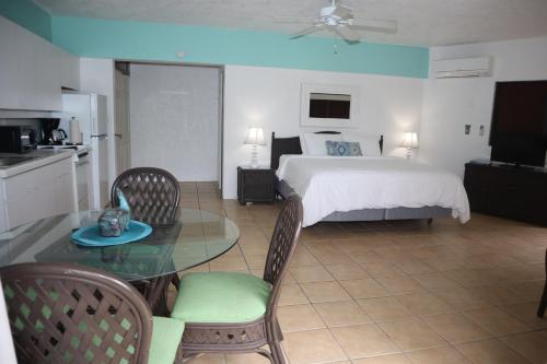 a bedroom with a bed and a table and chairs at Point Pleasant Resort® 1BR Suite with Ocean Views in Nazareth