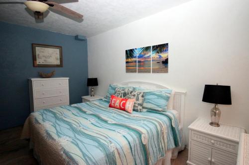 a bedroom with a bed and two dressers and a ceiling fan at Point Pleasant Resort® 1BR Suite with Ocean Views in Nazareth