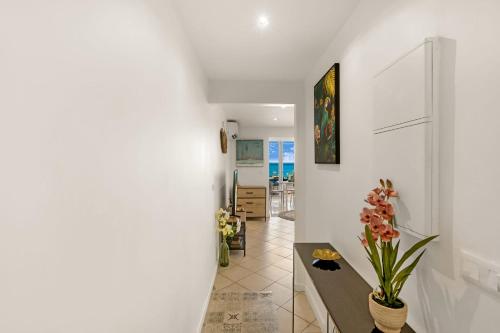 a hallway with white walls and a table at Watalibi - Beachfront apartment Grand-Case in Grand Case