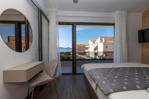 a bedroom with a bed and a large window at Villa Josip in Sukošan