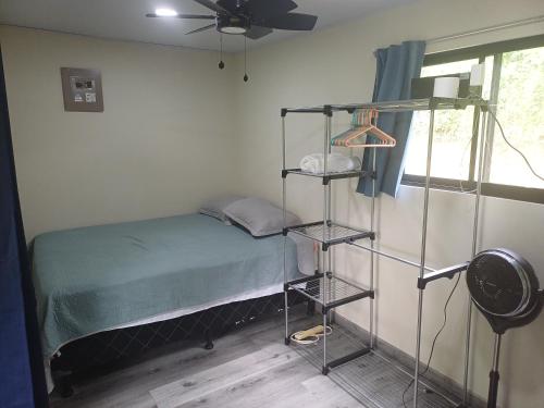 a bedroom with a bunk bed and a fan at Contenedor el Colibrí in Naranjo