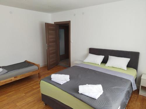 a bedroom with a bed with two pillows on it at Kravica Oasis in Ljubuški