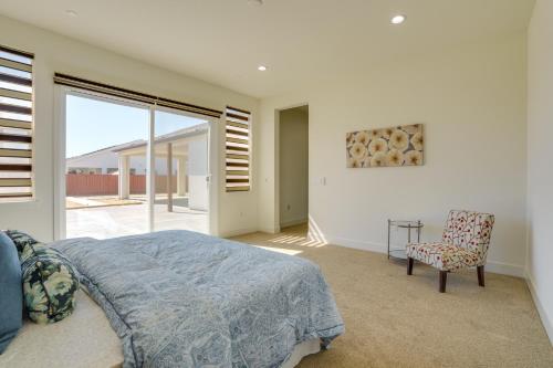a bedroom with a bed and a chair and a window at Private Yard & Patio! Modern Manteca Gem in Manteca