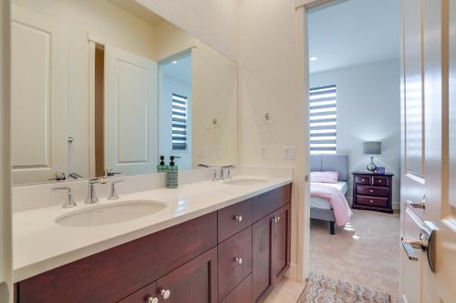 a bathroom with two sinks and a large mirror at Private Yard & Patio! Modern Manteca Gem in Manteca