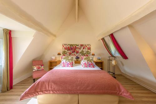 a bedroom with a bed in a attic at Les Manoirs de Tourgéville in Deauville