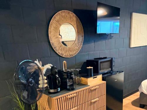 a kitchen with a microwave and a fan on a counter at Au bât Tournai chambre Bohème in Tournai