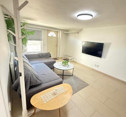a living room with a couch and a table at Lk Apartments in Halmstad