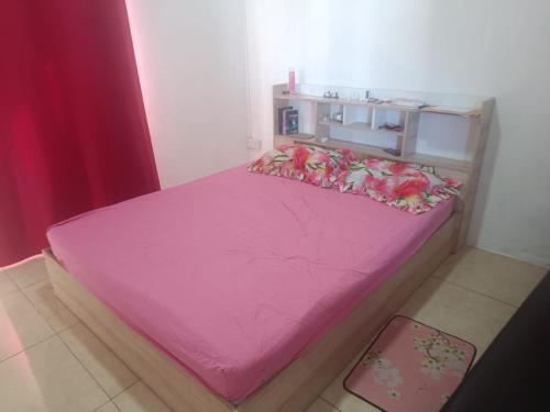 a bed with a pink sheets and a pink blanket at First floor apartment with view and balcony and with charming pool near sandy beach and commerces in Pointe aux Biches