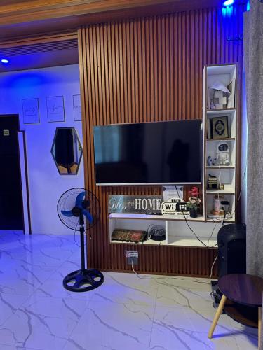 a living room with a large flat screen tv at LALEAH Transient House in Cotabato