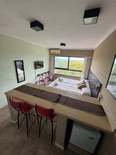 a bedroom with a large bed and red chairs at Río Victoria in Victoria