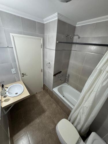 a bathroom with a toilet and a sink and a tub at Río Victoria in Victoria