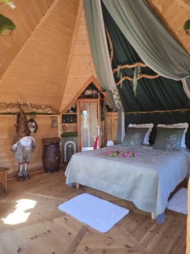 a bedroom with a bed in a tent at La Chaumière magique des Elfes et son escape game in Servas
