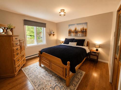 a bedroom with a large bed and a window at Chalet avec spa et lac privé in Saint Come