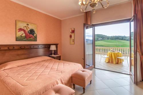 a bedroom with a bed and a sliding glass door at Hotel Federico II in Enna