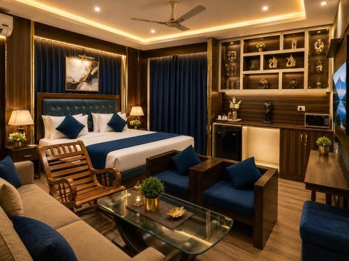 a bedroom with a bed and a living room at Castal Blue Hotel Near IGI Delhi Airport - Free Breakfast and Dinner complementry in New Delhi