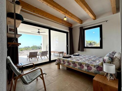 a bedroom with a bed and a large window at BnB Paradiso in Carloforte