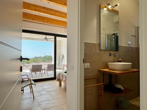 a bathroom with a sink and a mirror at BnB Paradiso in Carloforte