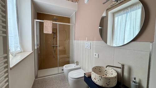 a bathroom with a toilet and a mirror at Lanizoladelroero in Sommariva Perno
