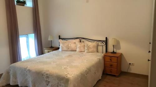 a bedroom with a bed and two lamps on a night stand at Unter der Linde in Tittmoning