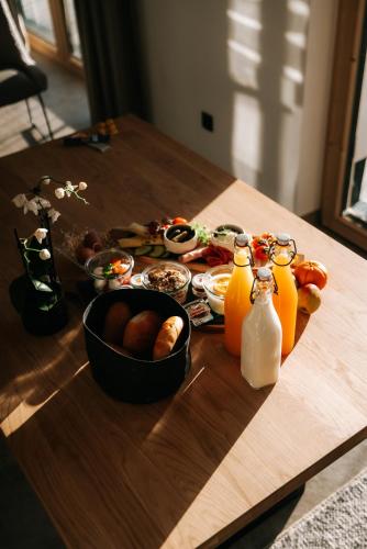 a table with food and bottles of orange juice at Leni Mountain Lodge in Sölden