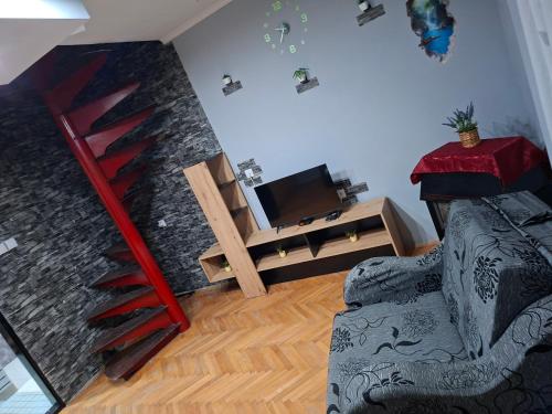 a living room with a staircase and a couch at Vikendica DUNAV in Golubac