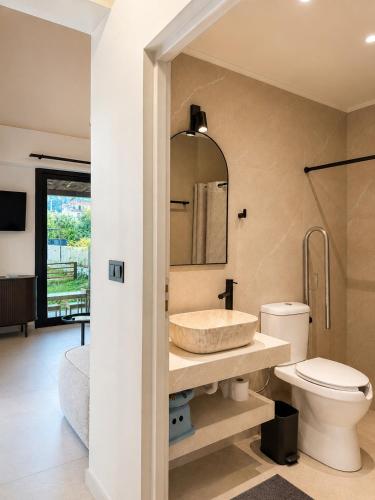 a bathroom with a sink and a toilet at athanasian side sea view home in Polychrono