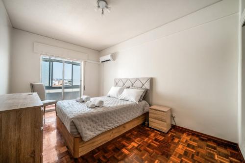 a bedroom with a bed and a large window at HolidaysPT - Luanda - 2 Bedroom Apartment in Olhão