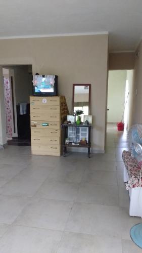 a living room with a dresser and a mirror at Casa Las Moras in La Rioja
