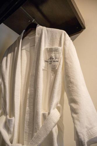 a white shirt is hanging on a rack at Rincon del Buey Resort in Copán Ruinas