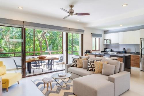a living room with a couch and a table at Bright 1 BD with private Terrace near TULUM in Akumal