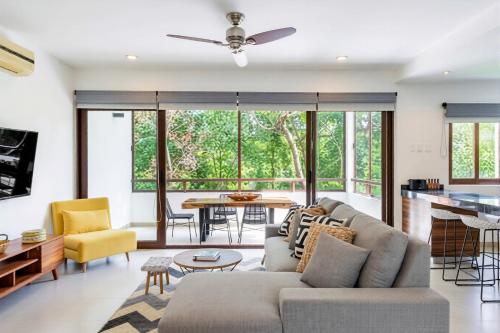 a living room with a couch and a table at Bright 1 BD with private Terrace near TULUM in Akumal