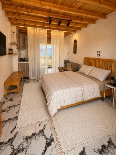 a bedroom with a large bed and a large window at Bedro Rooftop Studio 2 Private Balcony Sea View 30 Sec to Sea in Dahab