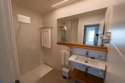 a bathroom with a sink and a shower and a mirror at Los Olivos Beach Resort in Adeje