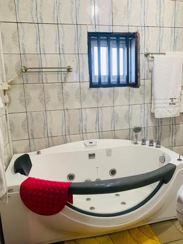 a bathroom with a bath tub with a shark head on it at Hotel Omnisport in Limbe