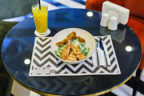 a bowl of food on a table with a drink at Hotel Intourist Palace Batumi in Batumi