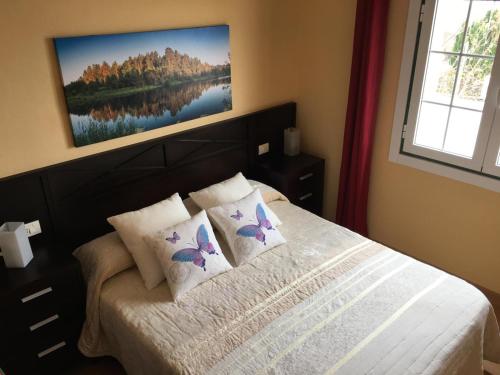 a bedroom with a bed with butterfly pillows at Casa el Durazno in Lodero