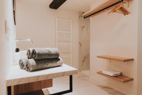 a bathroom with a pile of towels on a counter at Paulus41 in Antwerp