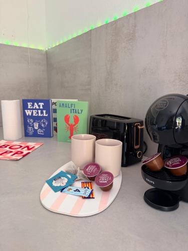 a counter top with a coffee maker and a toaster at Côté green in Juvignac