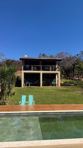 two lawn chairs sitting in front of a house at Chale2RabodeGalo in Santana do Riacho